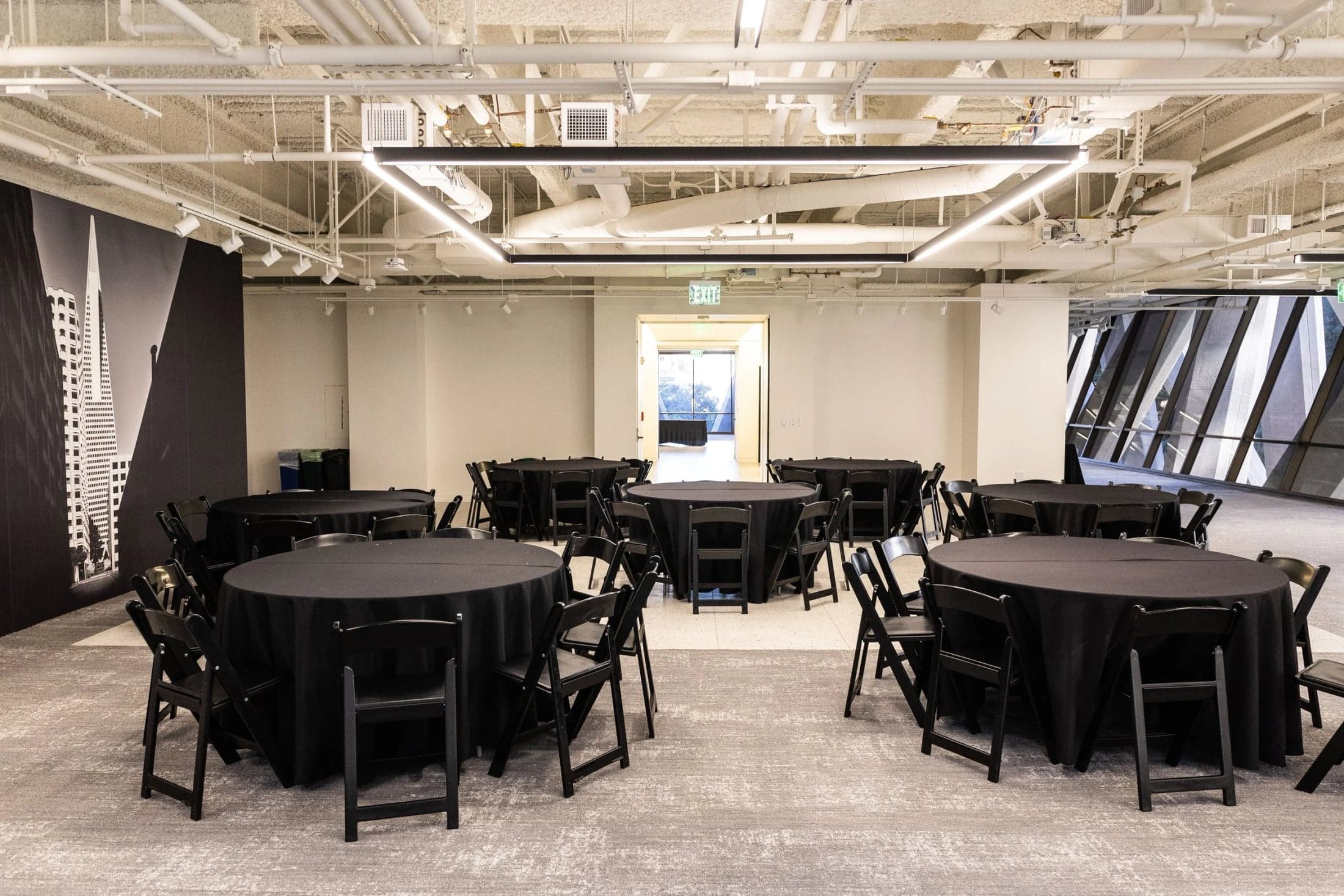 Round tables arranged in an event area at The Sandbox.